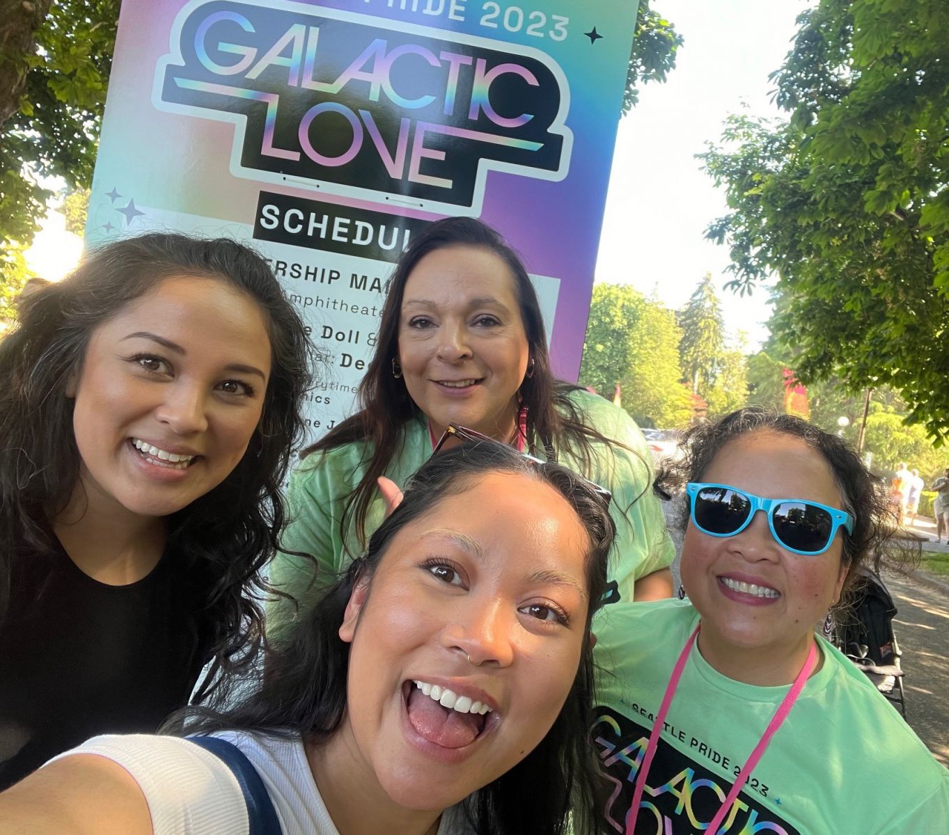 4 people in front of Galactic Love sign