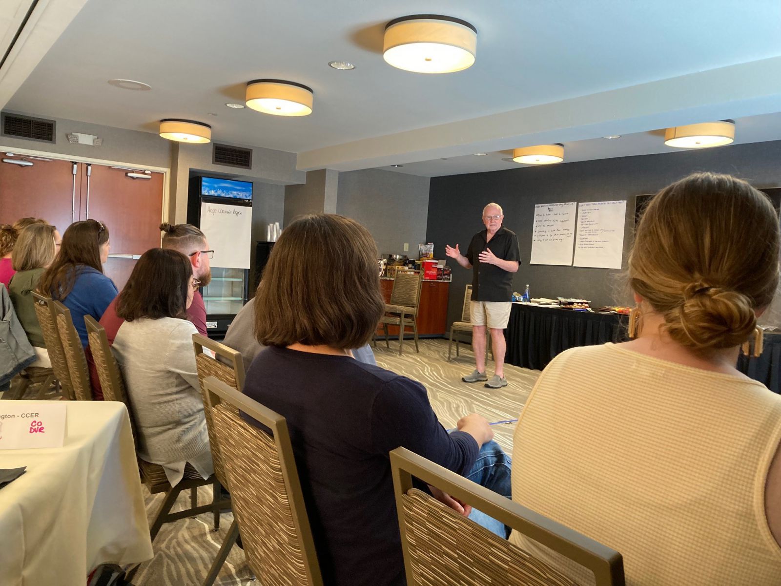 Paul presenting in front of a row of seated attendees.